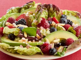 Plate of berry salad kombucha with avocados