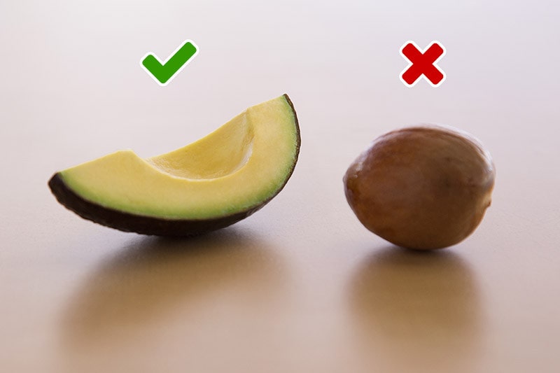 checkmark above a slice of avocado and an X above an avocado pit