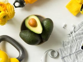 Bowl of avocados surrounded by healthy lifestyle items