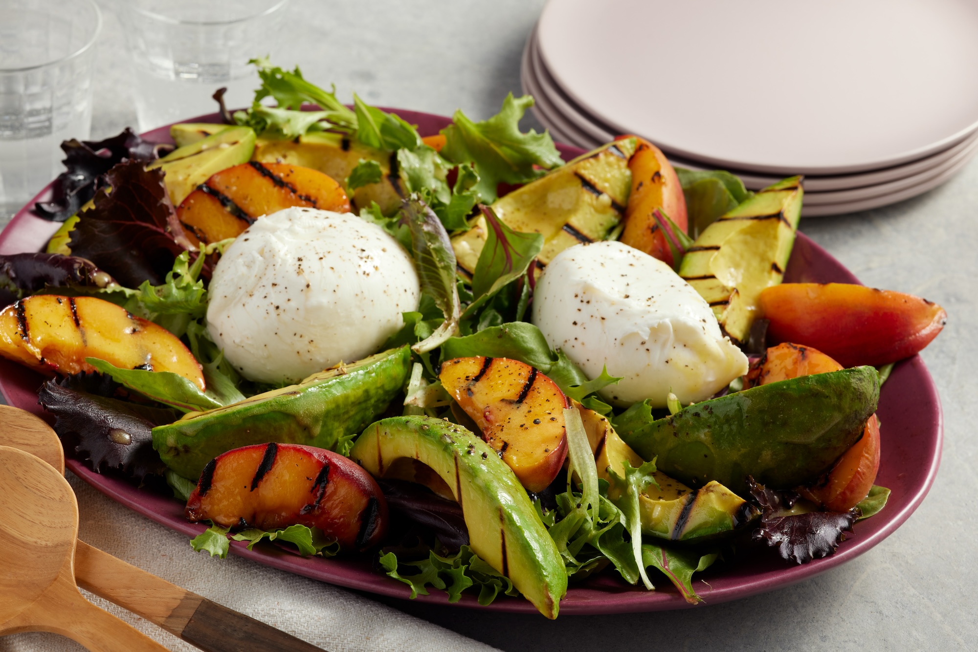 A photo of a Grilled Avocado, Peach and Burrata Salad